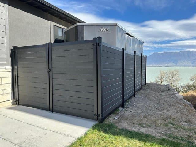 Gated equipment enclosure by SG Landscaping