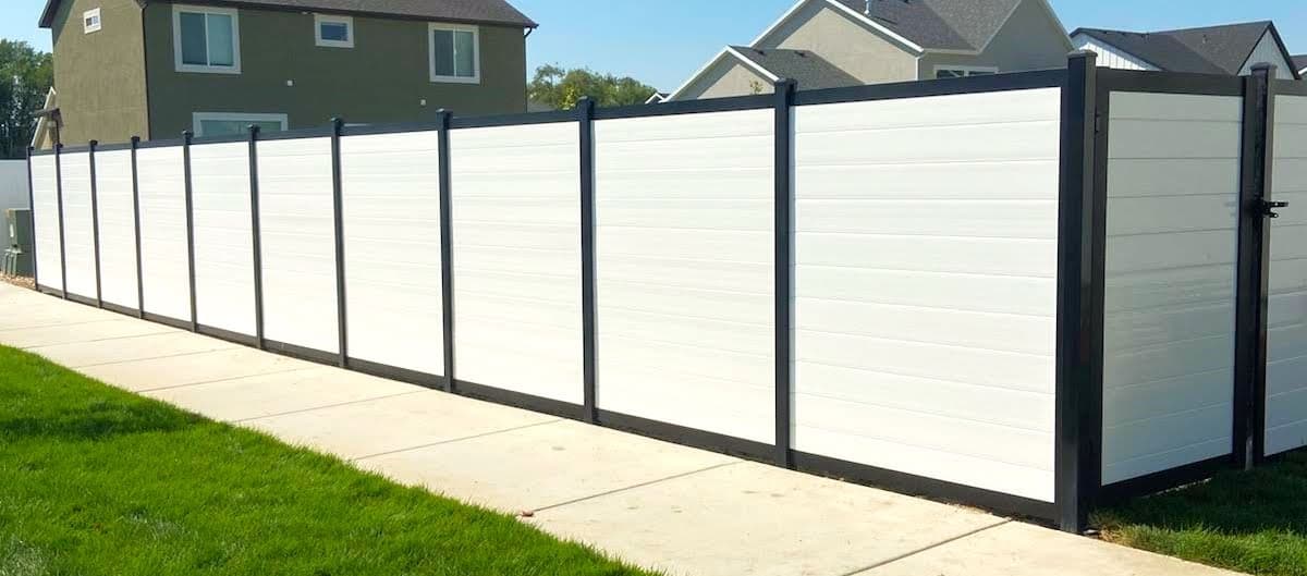 White privacy fence with black posts by SG Landscaping